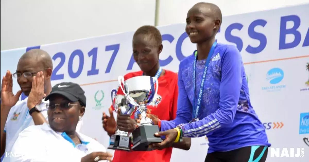 Rhoda Jepkhorir of Kenya, first female runner at the Lagos city marathon is also presented with her trophy. Photo: Emmanuel Osodi