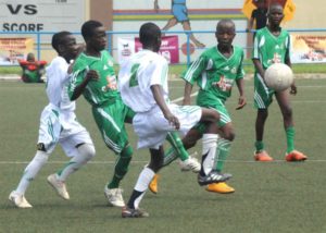 PIC. 40. DAMILOLA FOOTBALL CLUB (WHITE JERSEY) AND JOKERS STARS CHASING THE BALL AT THE FINAL OF THE 1ST UNDER-12 MRS KIDS' CUP IN LAGOS ON MONDAY (27/5/13).