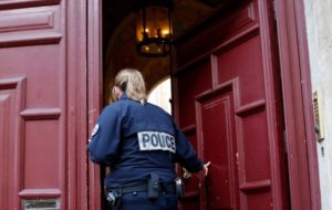 A police officer stands guard at the entrance of a luxury residence on the Rue Tronchet in central Paris, France, October 3, 2016 where masked men robbed U.S. reality TV star Kim Kardashian. (Reuters)